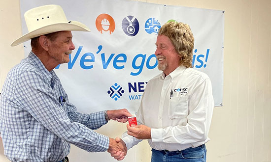 Presentation of Stop Work Authority Card. Greg Presley, Water-Wastewater Operator II (L), and Tommy Collier, Area Manager at Corix Texas (R).