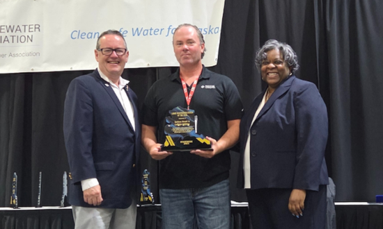 Alaska team representative receiving an award at annual ceremony.